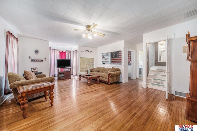 2860 335th St, Logan, IA 51546 - living area featuring light wood-style floors, visible vents, baseboards, and ceiling fan