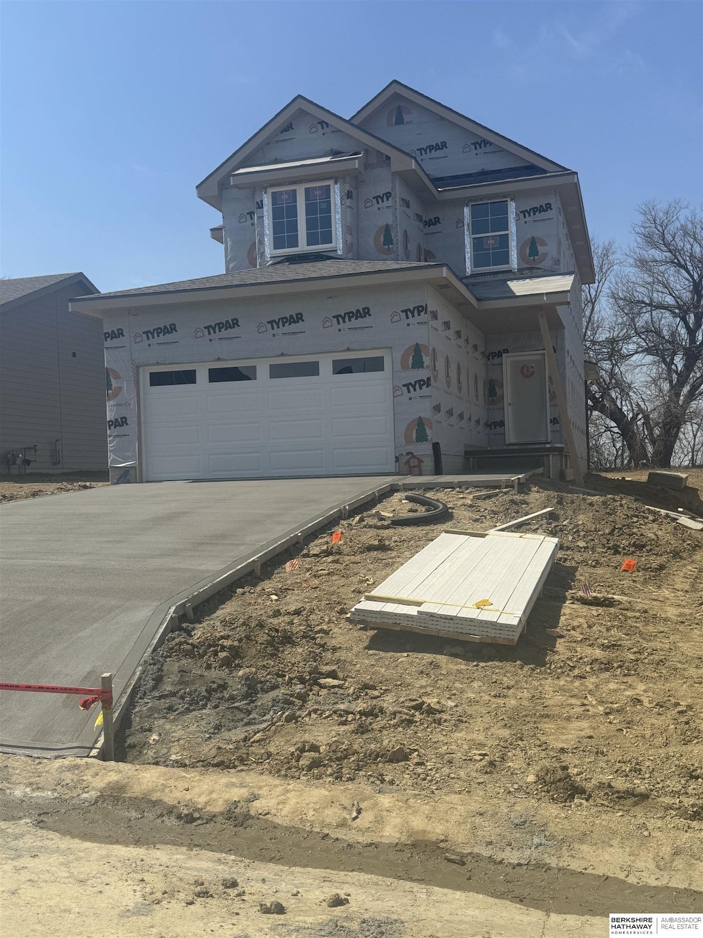 property in mid-construction featuring driveway and a garage