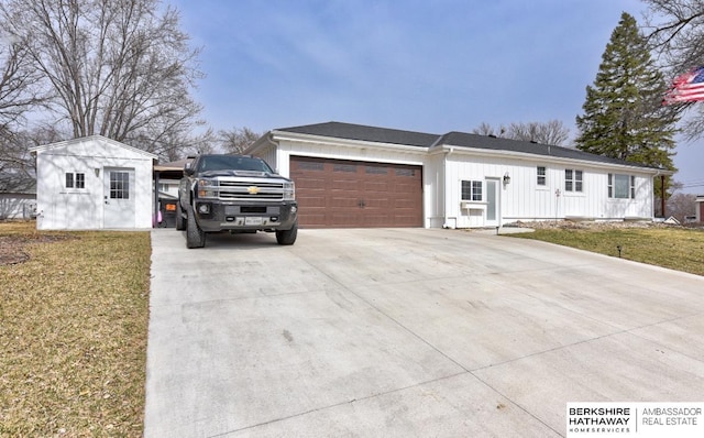 161 S Linden St, Wahoo, NE 68066 - view of front of house with board and batten siding, driveway, a garage, and a front lawn