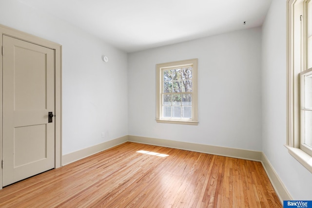 spare room with light wood finished floors and baseboards