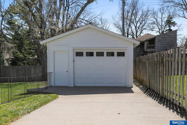 detached garage with driveway and fence