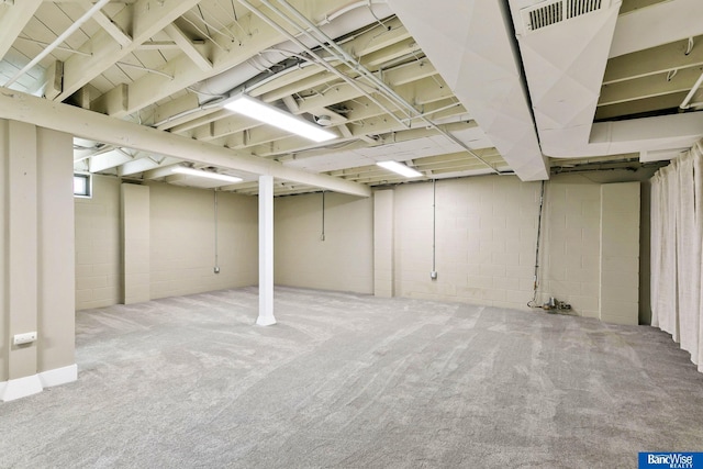 basement with carpet flooring and visible vents