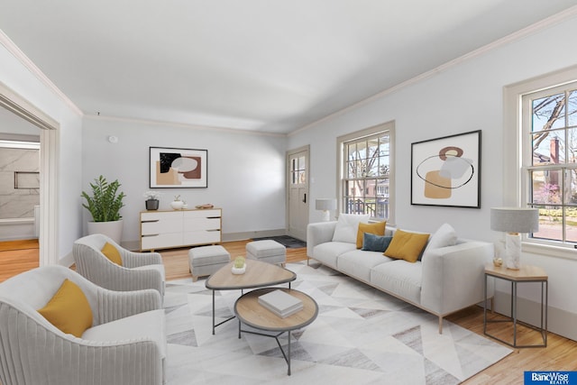 living room featuring a wealth of natural light, light wood-style flooring, and crown molding