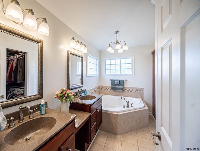full bathroom with a garden tub, tile patterned floors, a sink, and double vanity