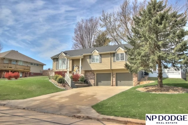 bi-level home with a front yard, driveway, and an attached garage