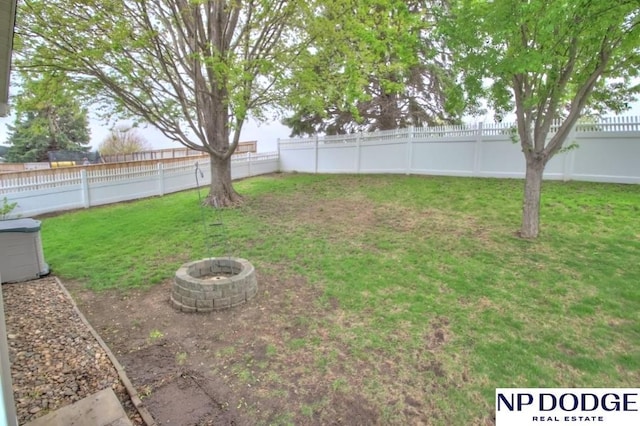 view of yard with a fire pit and a fenced backyard