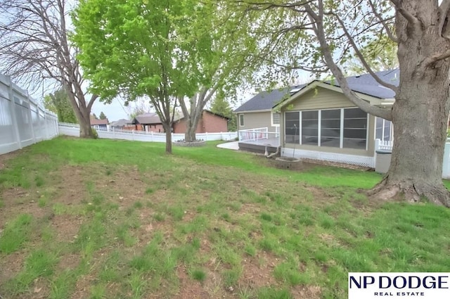 view of yard with a sunroom and fence