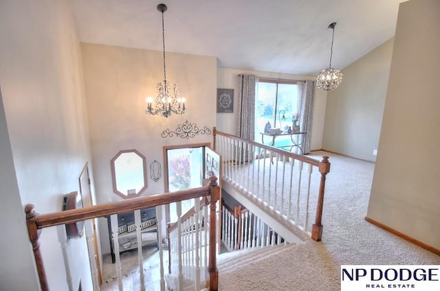stairway featuring an inviting chandelier, baseboards, and carpet floors