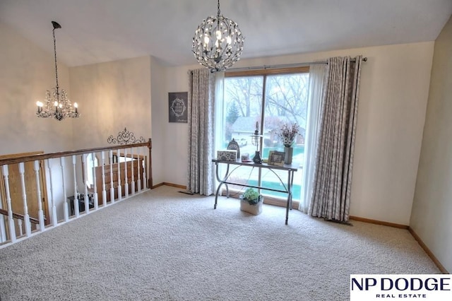 interior space with carpet flooring, a chandelier, and baseboards