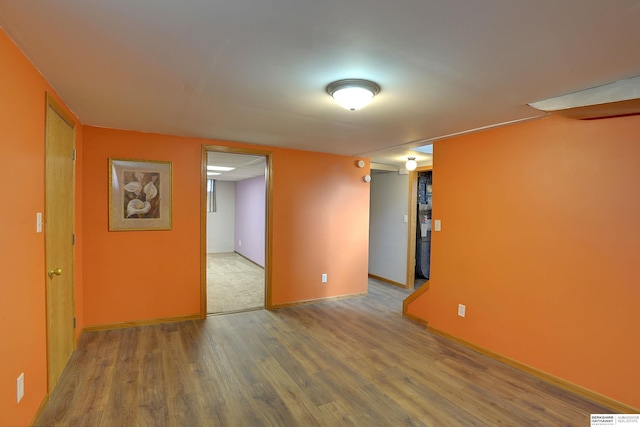 empty room with baseboards and wood finished floors