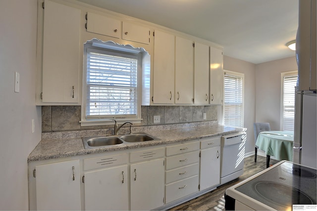 kitchen featuring white dishwasher, a sink, electric stove, wood finished floors, and backsplash