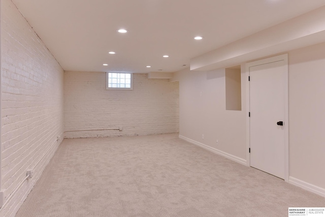 below grade area featuring brick wall, recessed lighting, visible vents, and carpet floors
