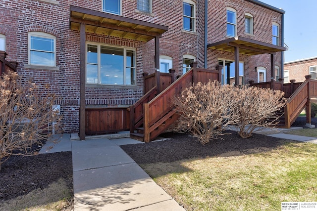 doorway to property featuring brick siding