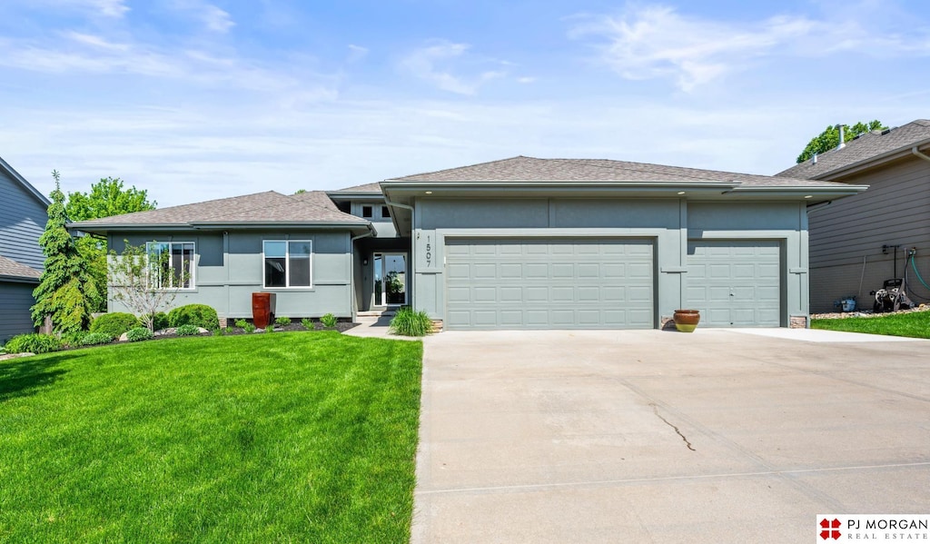 1507 N 181st Ave, Omaha, NE 68022 - view of front of home featuring stucco siding, concrete driveway, an attached garage, and a front lawn