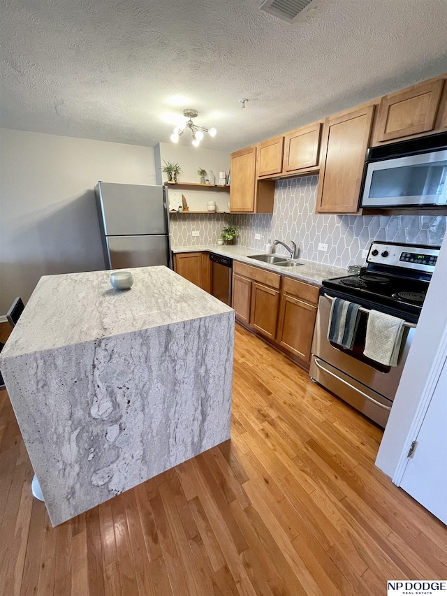 105 N 31st Ave Unit 607, Omaha, NE 68131 - kitchen with a sink, light countertops, light wood-type flooring, and stainless steel appliances