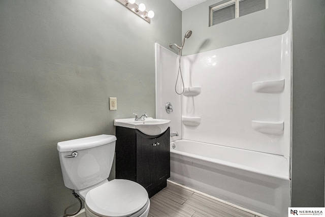 full bathroom with toilet, vanity, and shower / tub combination