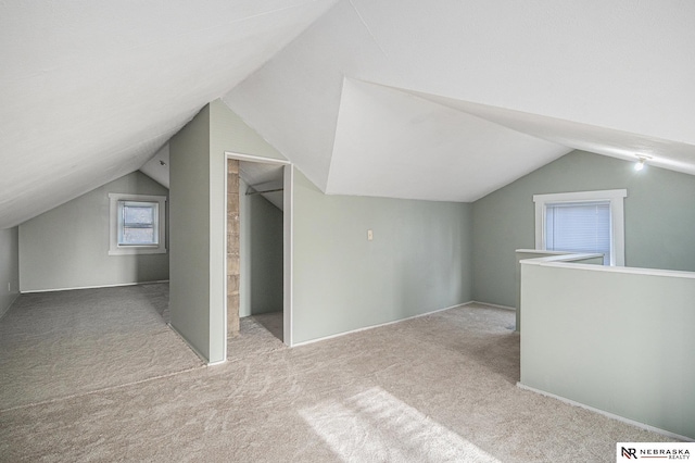 bonus room with carpet and lofted ceiling