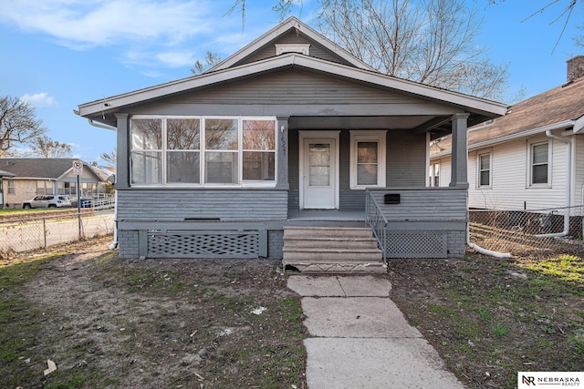 view of front facade featuring a porch and fence