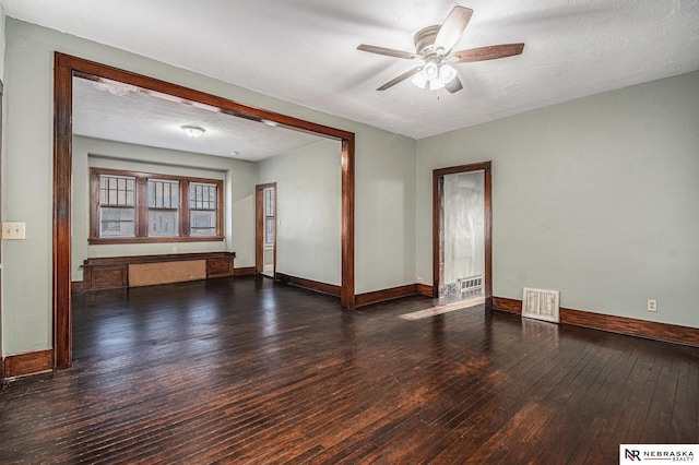 unfurnished room with visible vents, baseboards, ceiling fan, and hardwood / wood-style floors