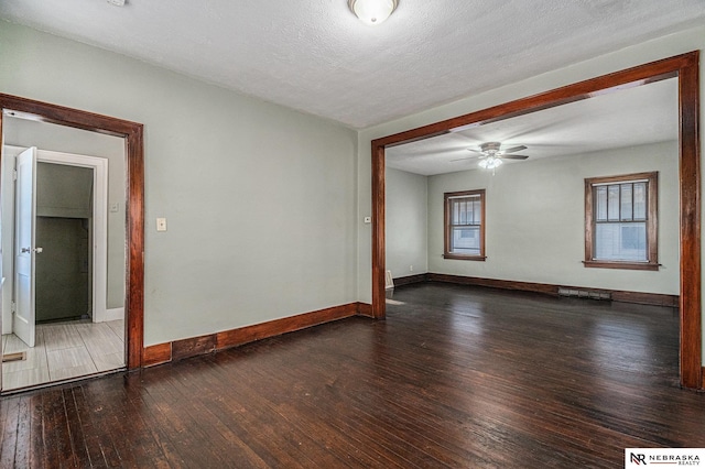 unfurnished room with ceiling fan, visible vents, hardwood / wood-style floors, a healthy amount of sunlight, and baseboards