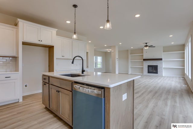 11014 N 161st St, Bennington, NE 68007 - kitchen featuring tasteful backsplash, a stone fireplace, a ceiling fan, dishwasher, and a sink
