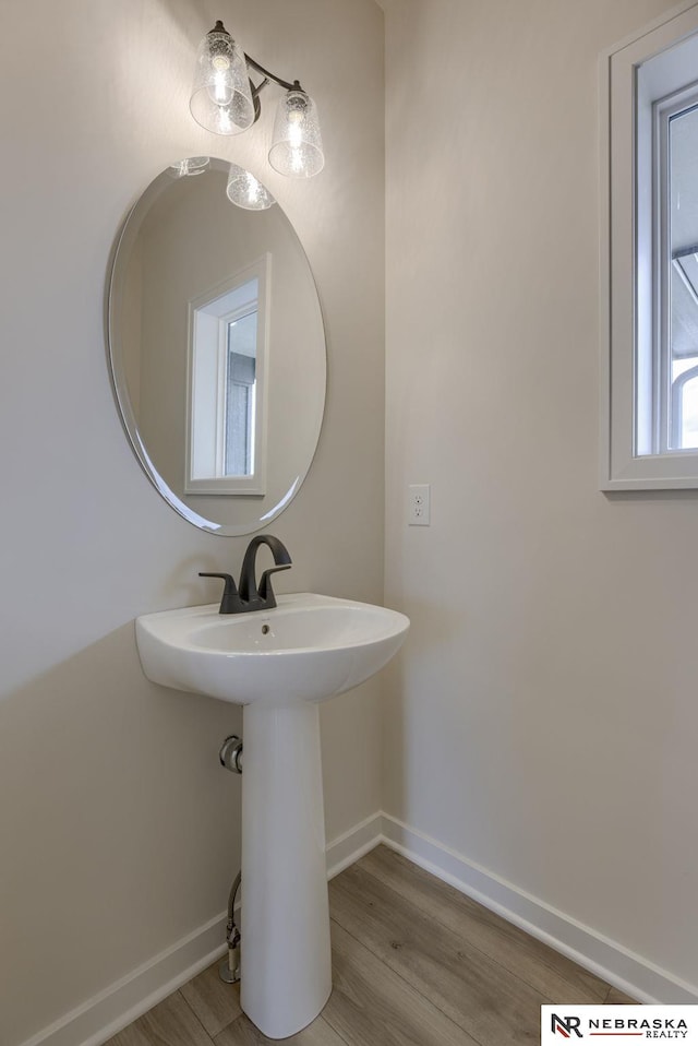 11014 N 161st St, Bennington, NE 68007 - bathroom featuring a sink, baseboards, and wood finished floors
