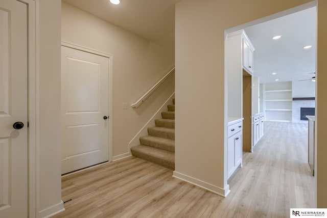 11014 N 161st St, Bennington, NE 68007 - staircase featuring built in features, baseboards, a ceiling fan, and wood finished floors