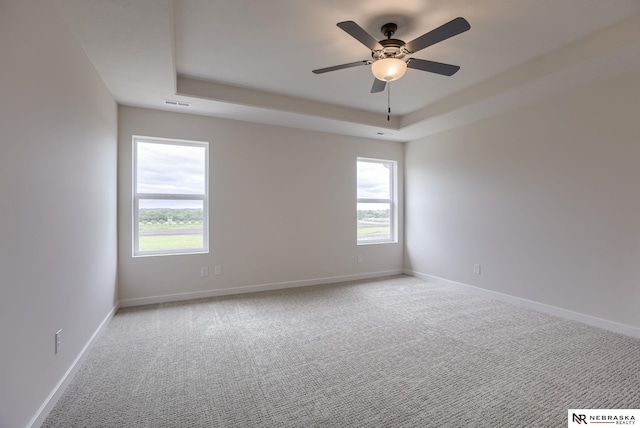 11014 N 161st St, Bennington, NE 68007 - spare room featuring a raised ceiling, visible vents, carpet, and plenty of natural light