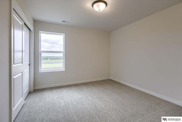 11014 N 161st St, Bennington, NE 68007 - unfurnished bedroom featuring visible vents, baseboards, a closet, and carpet floors