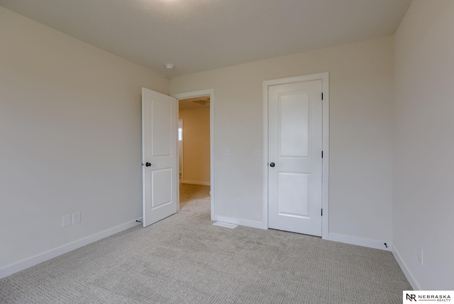 11014 N 161st St, Bennington, NE 68007 - unfurnished bedroom featuring light colored carpet, baseboards, and visible vents