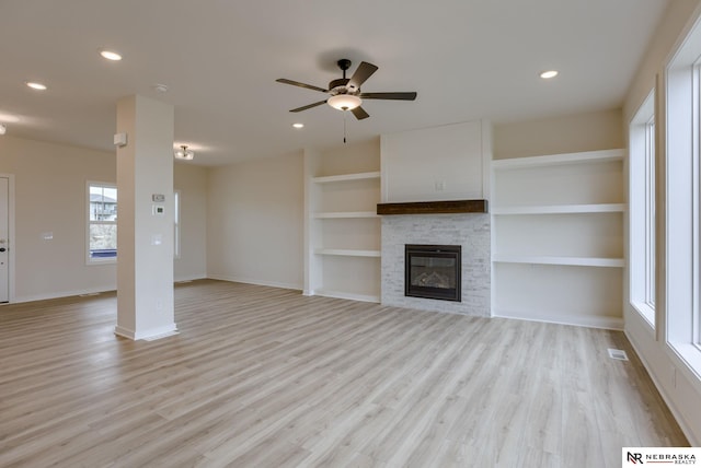 11014 N 161st St, Bennington, NE 68007 - unfurnished living room featuring light wood-type flooring, baseboards, a ceiling fan, and visible vents