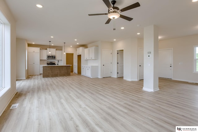 11014 N 161st St, Bennington, NE 68007 - unfurnished living room featuring light wood-style flooring, a ceiling fan, visible vents, and recessed lighting