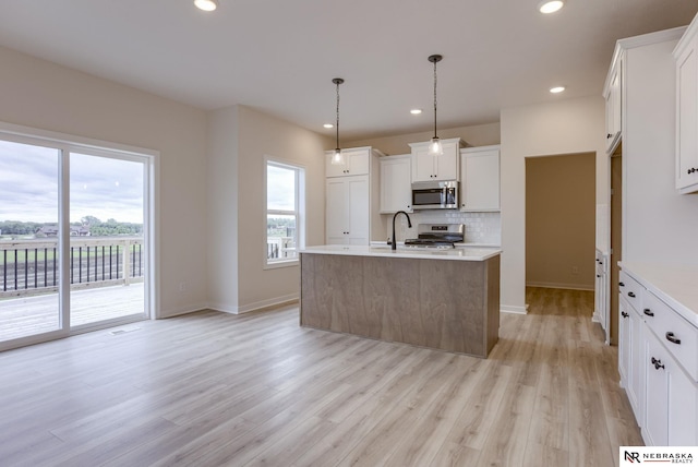 11014 N 161st St, Bennington, NE 68007 - kitchen with light wood-type flooring, recessed lighting, light countertops, stainless steel appliances, and decorative backsplash