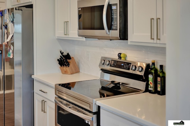 kitchen with white cabinetry, light countertops, tasteful backsplash, and appliances with stainless steel finishes
