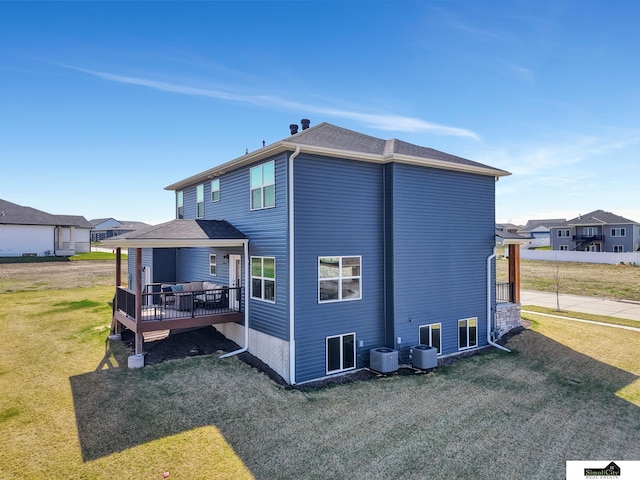 back of house featuring a yard, central AC, and a wooden deck