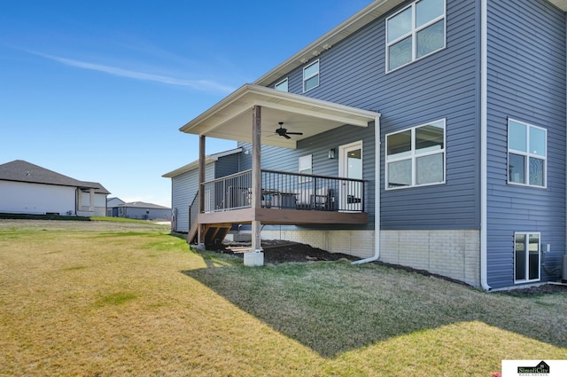 rear view of house with a yard and ceiling fan