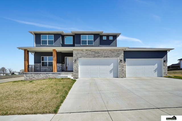 prairie-style home featuring driveway, stone siding, a front lawn, a garage, and covered porch