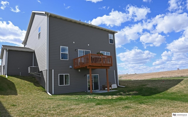 back of house with a yard, a patio area, and a deck