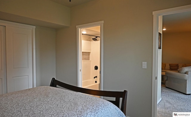 bedroom featuring connected bathroom and light carpet