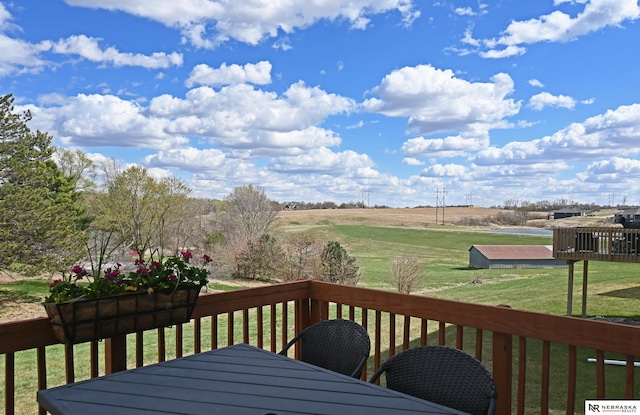 deck featuring a yard and outdoor dining area