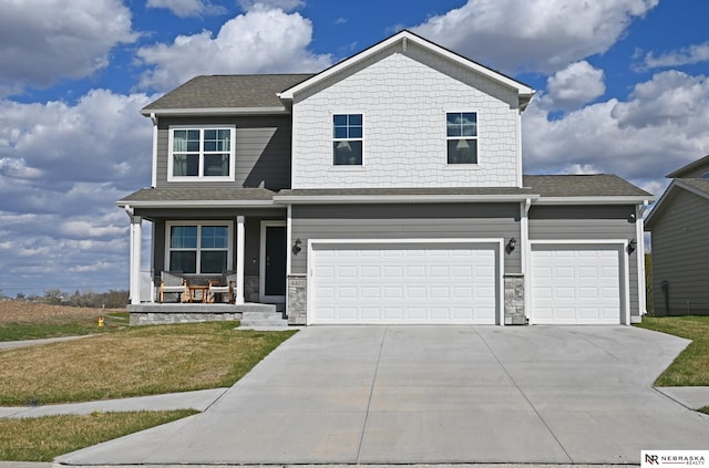view of front facade featuring driveway, stone siding, a front lawn, an attached garage, and covered porch