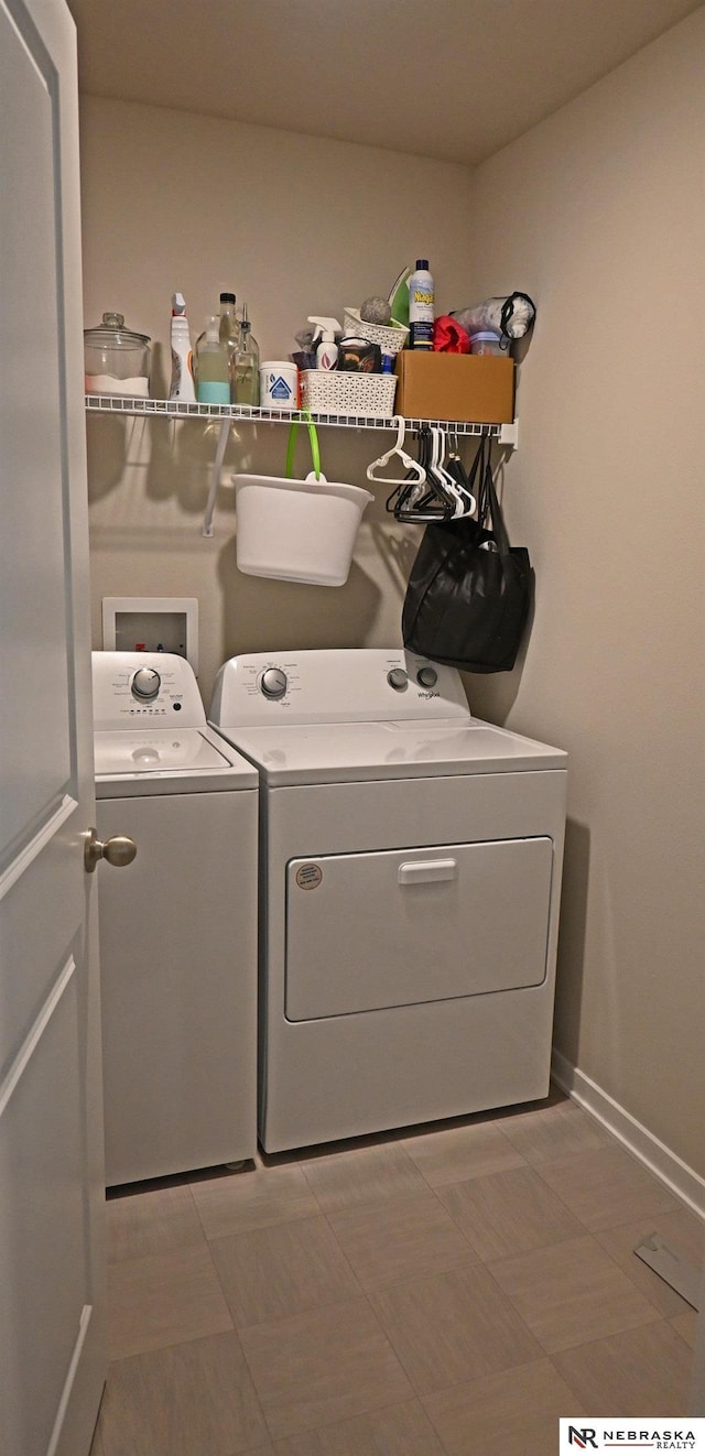 laundry room with laundry area, washing machine and clothes dryer, baseboards, and light floors