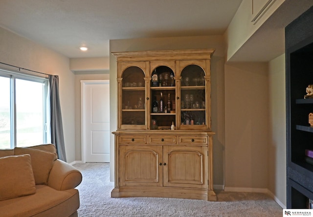 interior space with light colored carpet and baseboards