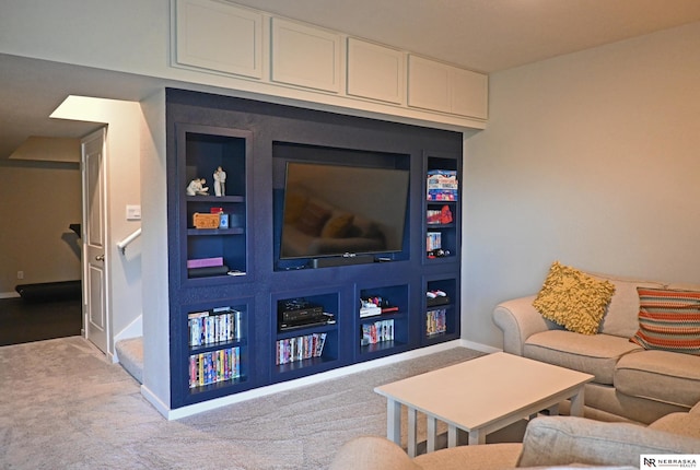 living room featuring baseboards, carpet, and built in shelves
