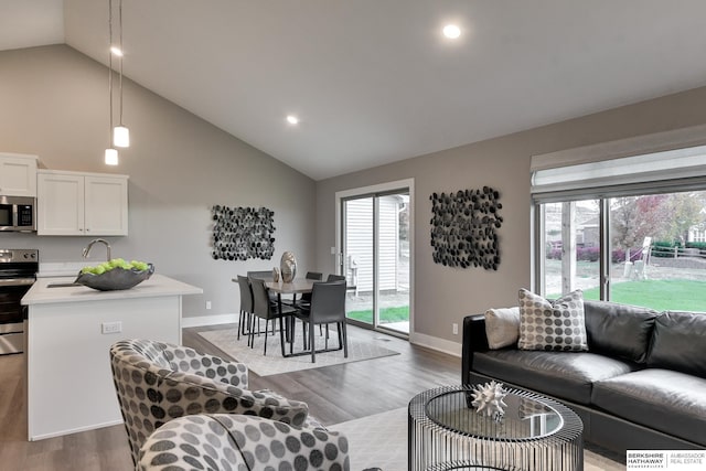 19714 Piney Creek Dr, Elkhorn, NE 68022 - living area with light wood-style floors, high vaulted ceiling, baseboards, and a wealth of natural light