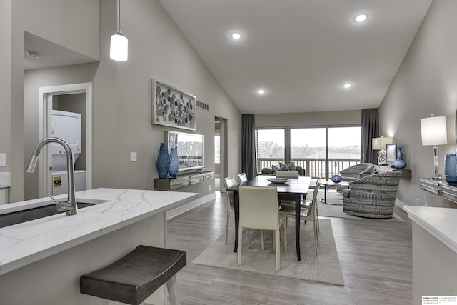 17045 Hawthorne Ave, Omaha, NE 68118 - dining room featuring visible vents, baseboards, recessed lighting, light wood finished floors, and high vaulted ceiling