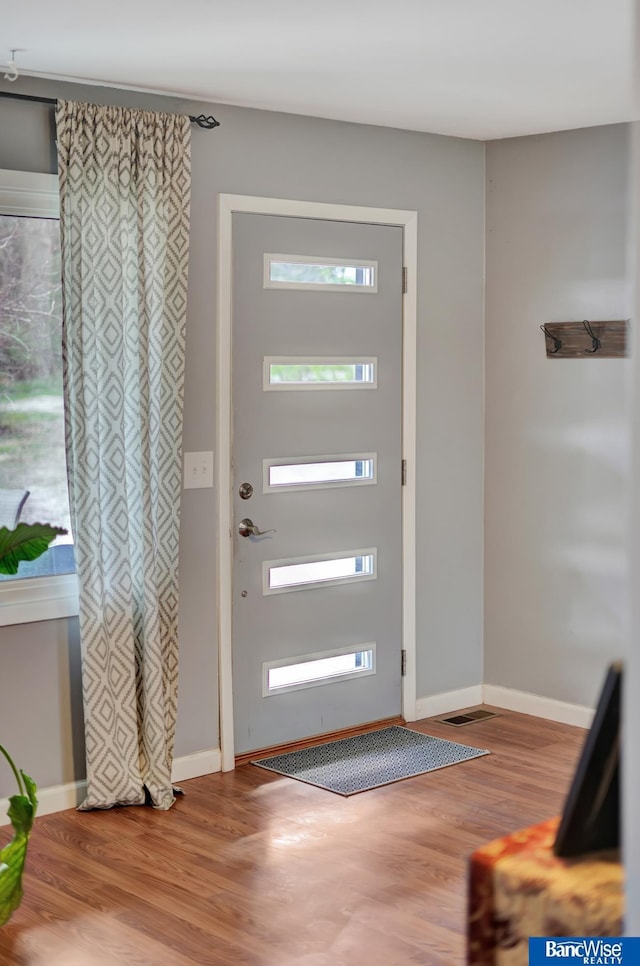 entryway featuring wood finished floors and baseboards