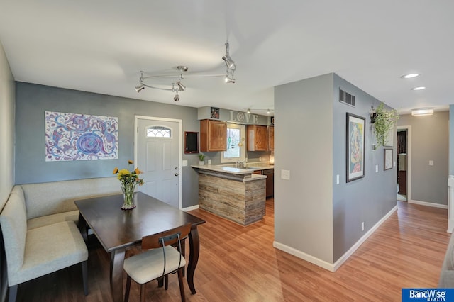 dining space featuring baseboards, rail lighting, recessed lighting, light wood-style flooring, and visible vents