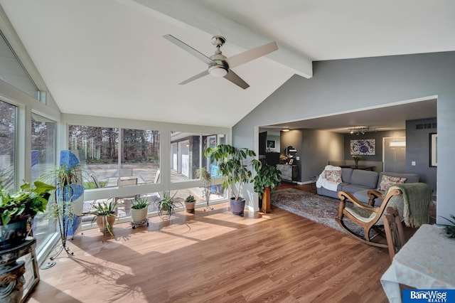 sunroom / solarium with visible vents, wood finished floors, high vaulted ceiling, and beam ceiling