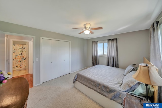 carpeted bedroom with a closet, baseboards, and ceiling fan